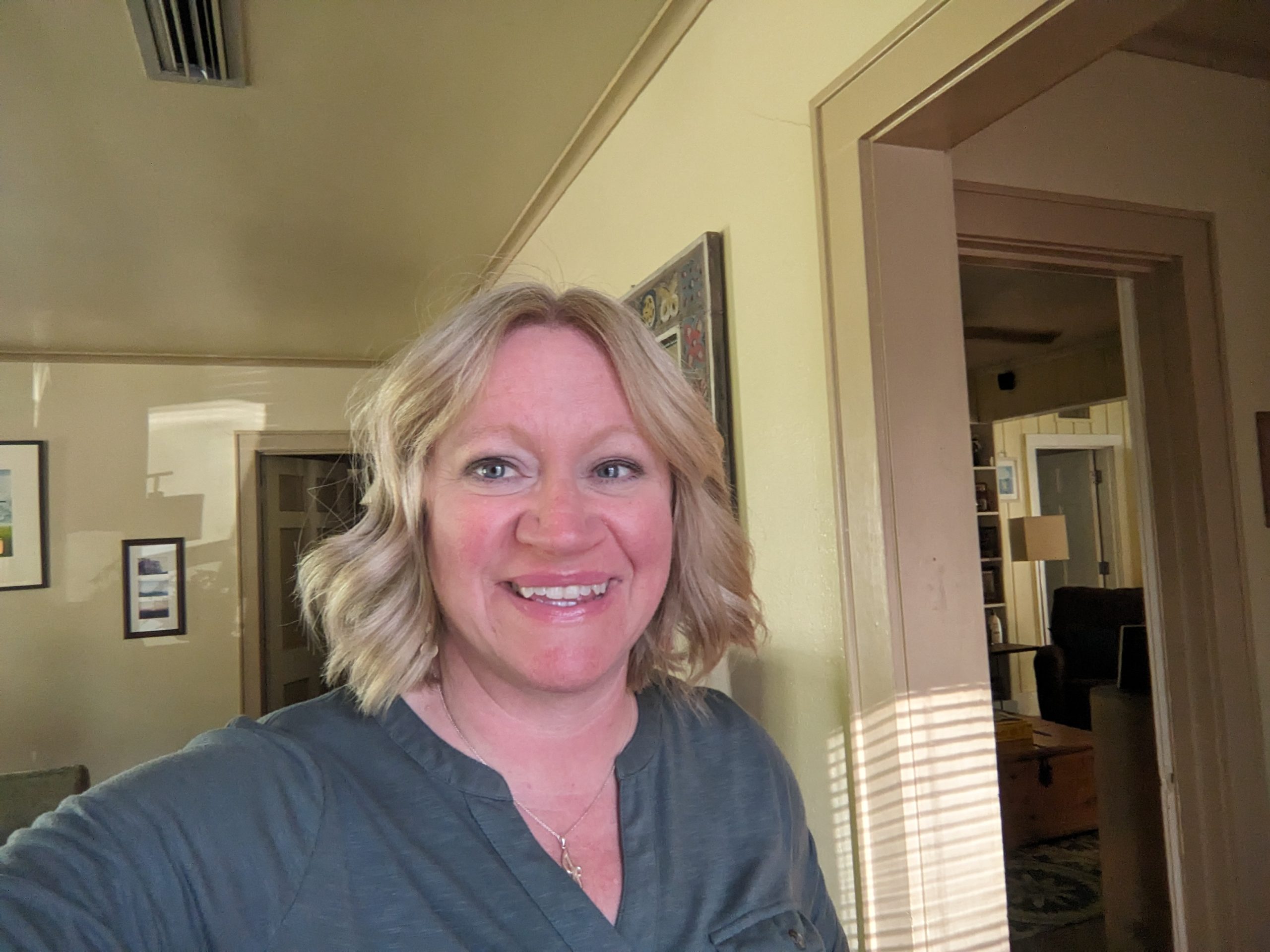 Mrs. McGuirk smiling in her home. (Editor Note: Very unhelpful for knowing what class she teaches)