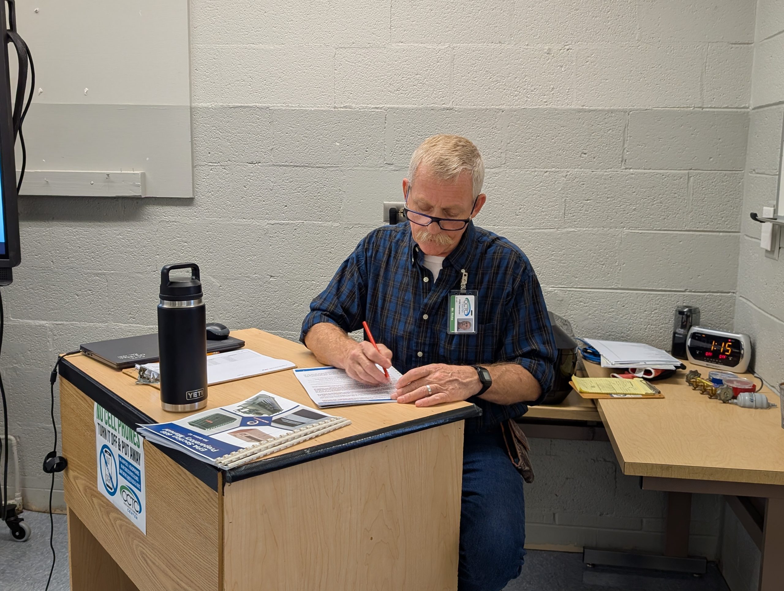 Mr. Ricks writing something down.