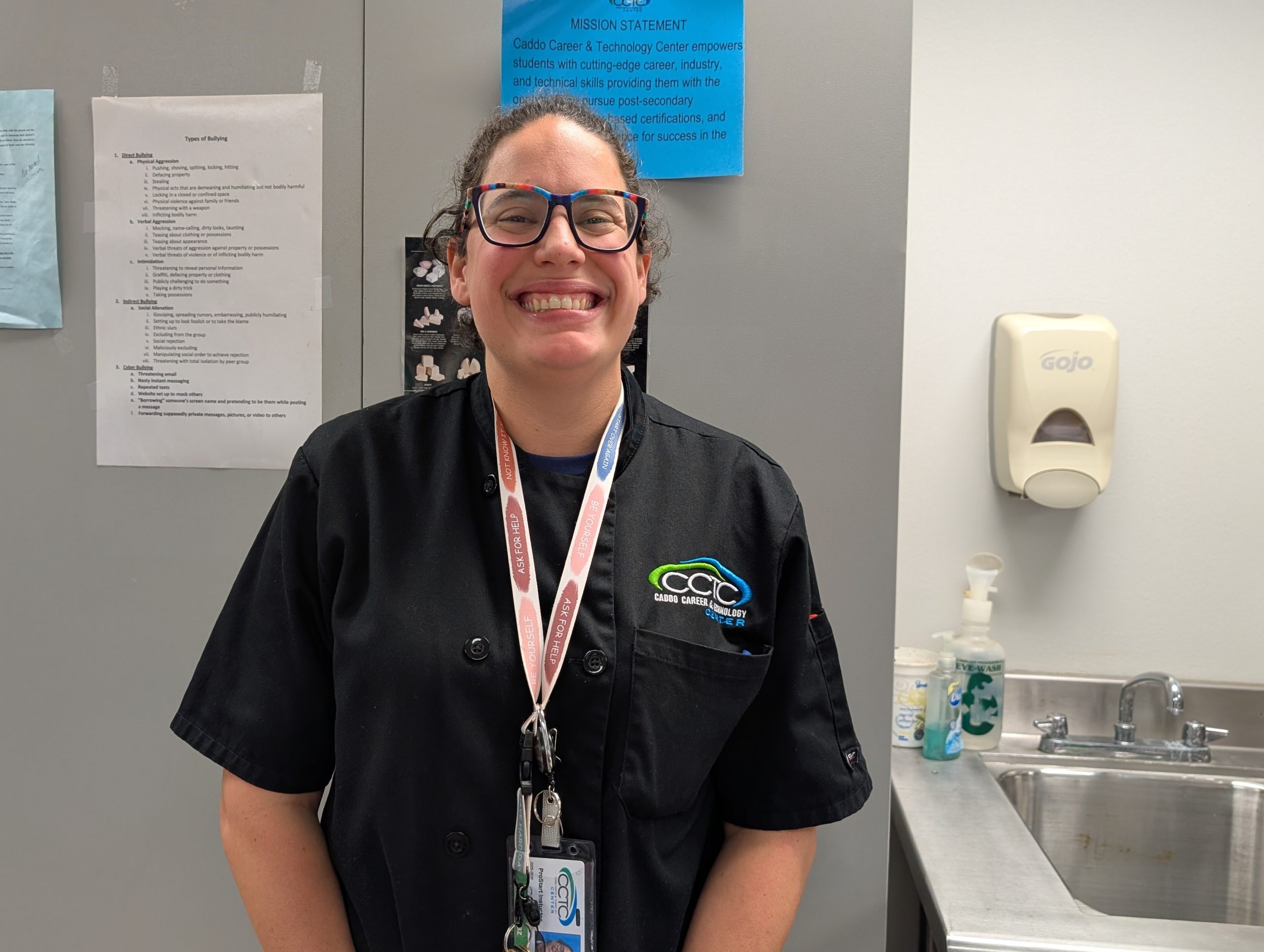 Ms. Diaz standing with a very cartoonish smile.