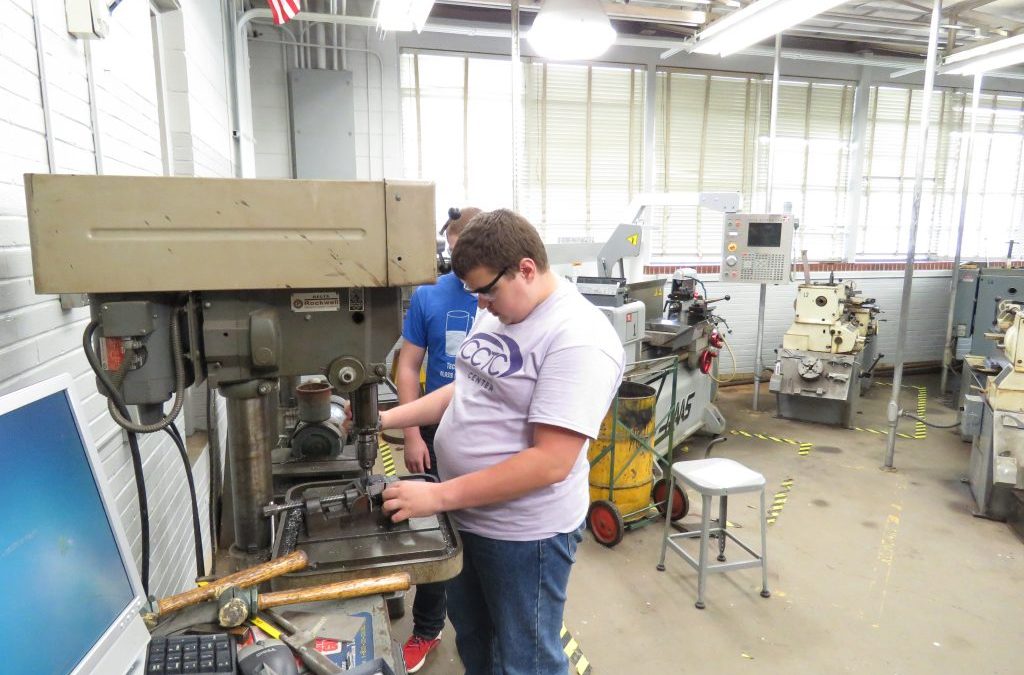 Machining students layout, drill, and tap a practice block.